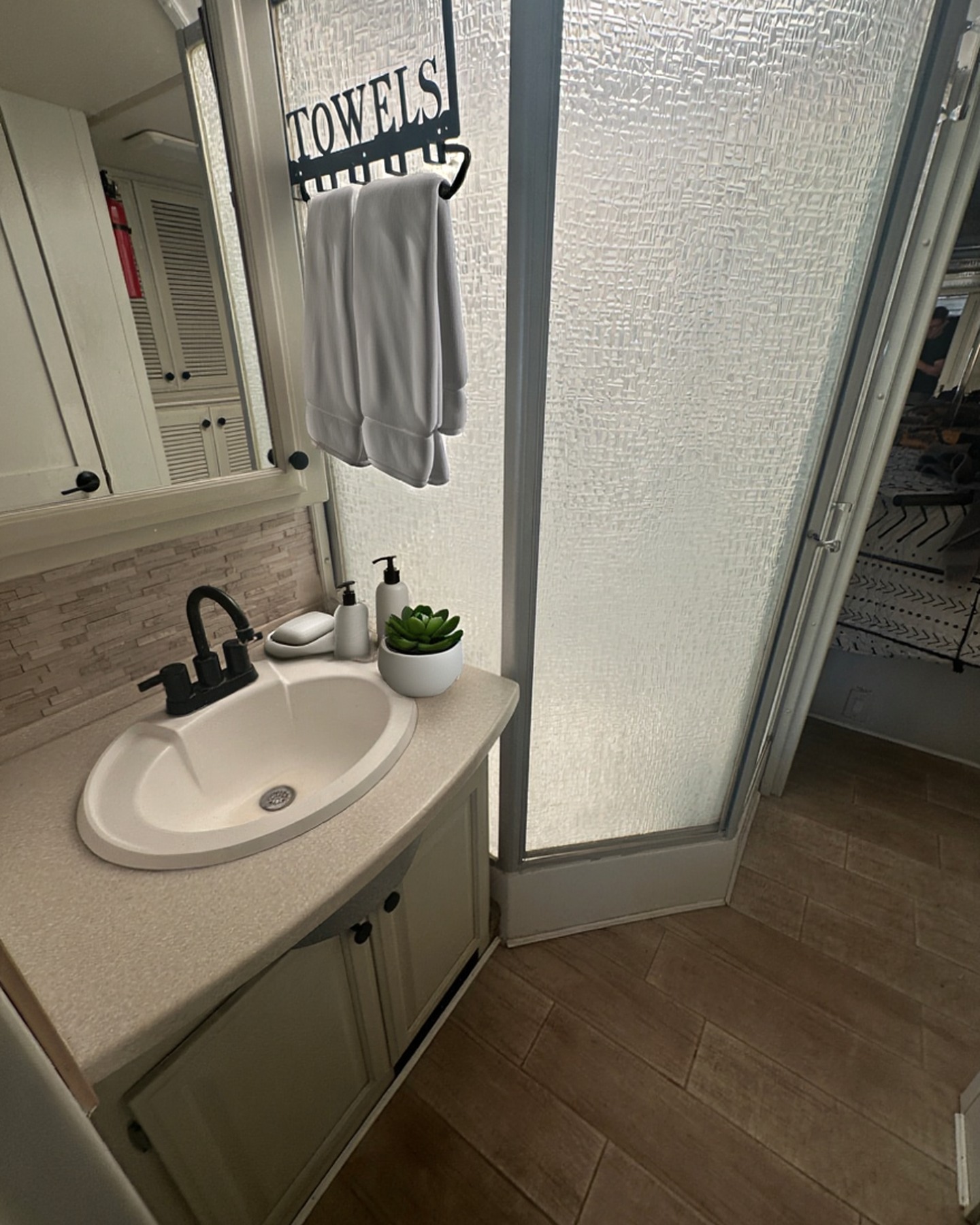 2004 Fleetwood Revolution 40C — Bathroom vanity with glass shower enclosure — Palm Desert CA