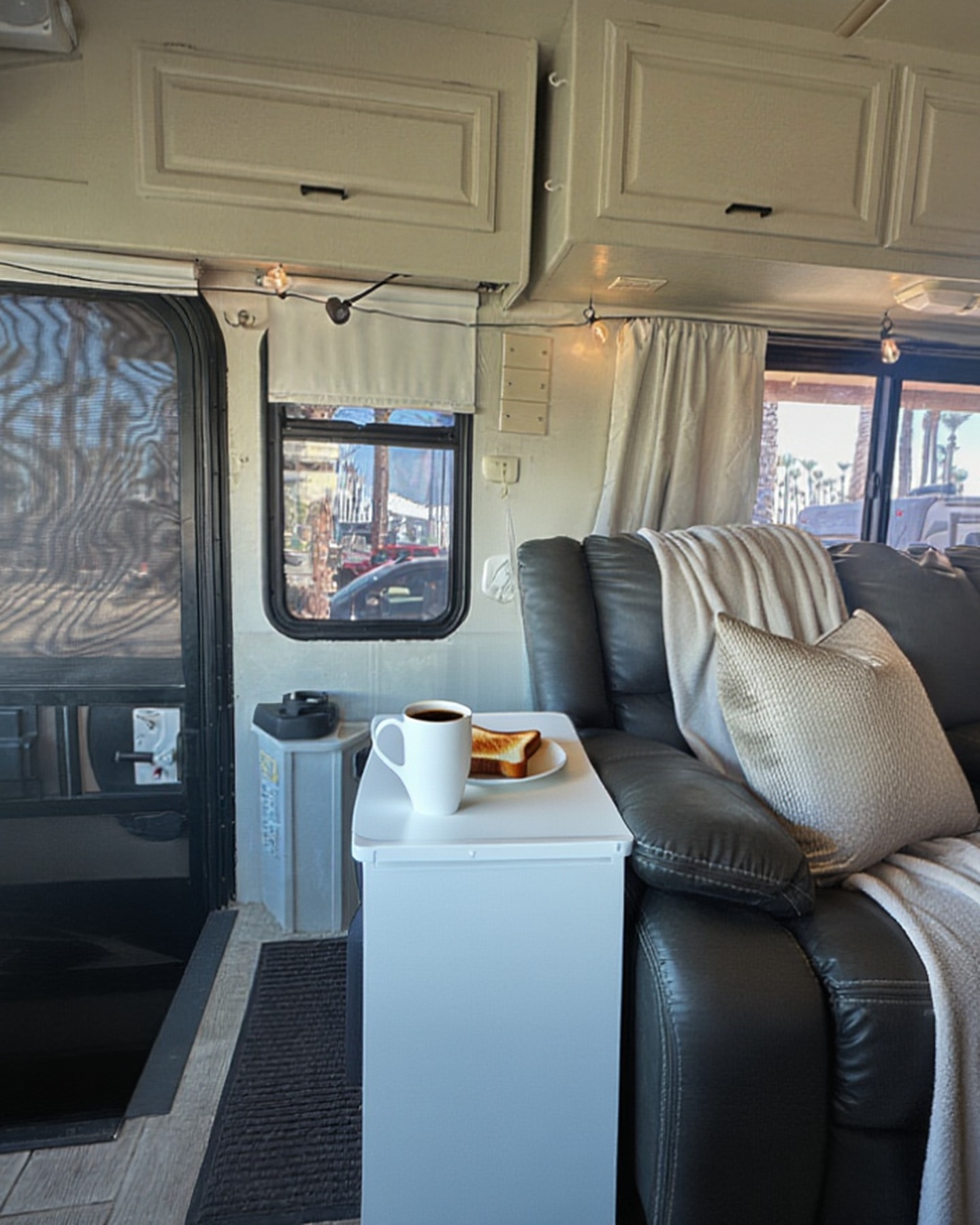 2004 Fleetwood Revolution 40C — Living area sofa, entry-door perspective — Palm Desert CA