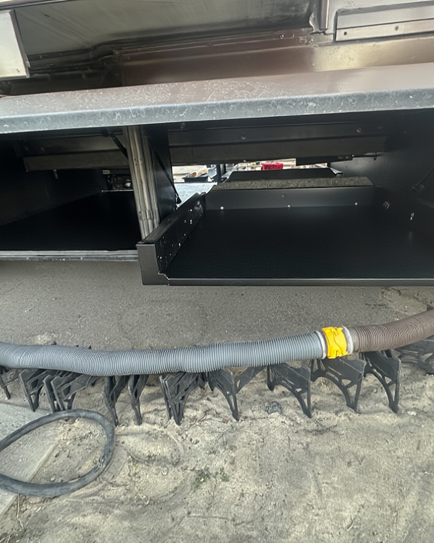 2004 Fleetwood Revolution 40C — Driver-side basement bay with hose storage — Palm Desert CA